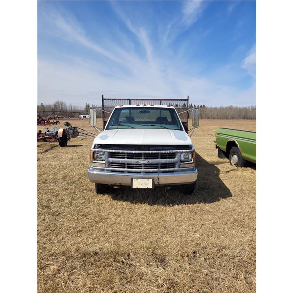 2000 Chev white 3500 Flat Deck, good body, V8 Vortec 5Spd Manual Has keys 8'x 12' deck fold down sid