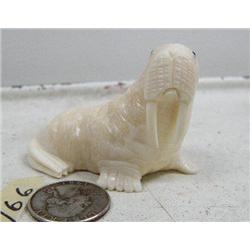 Carved ivory walrus by R. Silook with inset baleen eyes, 2-1/2" (86)