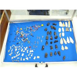 Display case of: beads, pendants, fetishes, arrowheads, etc. (114)