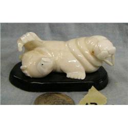 Carved ivory walrus and baby walrus on baleen base by Ronnie Toolie of Savoonga, Alaska- base is 3" 