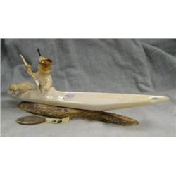 Carved ivory Aleut hunter in baidarka by Roger Silook- approx. 8-1/4" long