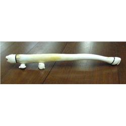 Walrus oosik with carved white ivory walrus on one end and polar bear head on other, mounted on carv