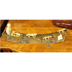 15-1/2" long dog team mounted on mammoth ivory with three bone dogs and bone man, wood sled, ivory s