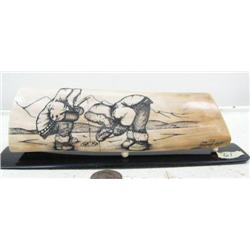 Fabulous scrimshaw by Homer Cole of 2 Eskimo ice fishing- note the detail on the pants- 7-1/2" long 