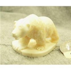 Carved white ivory bear by Don Savage- 1-3/8" tall, 2-1/8" wide
