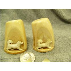 Ivory salt and pepper shakers with a husky on each one