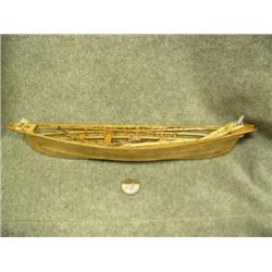 Skin umiak complete with 4 harpoons, 2 seal poke, and 4 oars- 12-3/4"