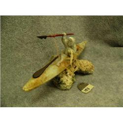 Soapstone kayaker mounted on bone- 3-1/4" tall, 8" long (2)