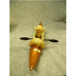 "Eskimo Hunter" by Jesse Higgins- kayak made from wood; hunter, seal, seal poke made from soapstone;