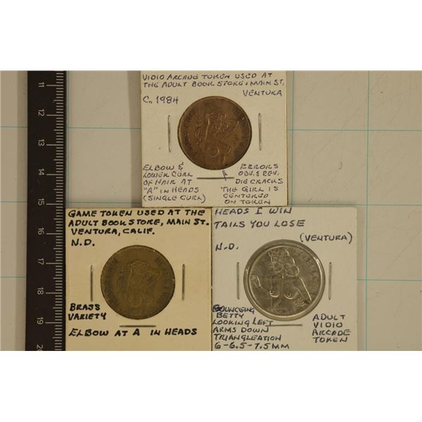 3 ADULT THEMED METAL FLIPPER TOKENS: HEADS I