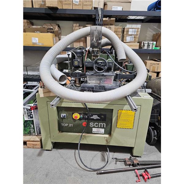 SCM top 21 multi spindle drilling machine, runs on 3 phase 220 volt power with a twistlock cord end.