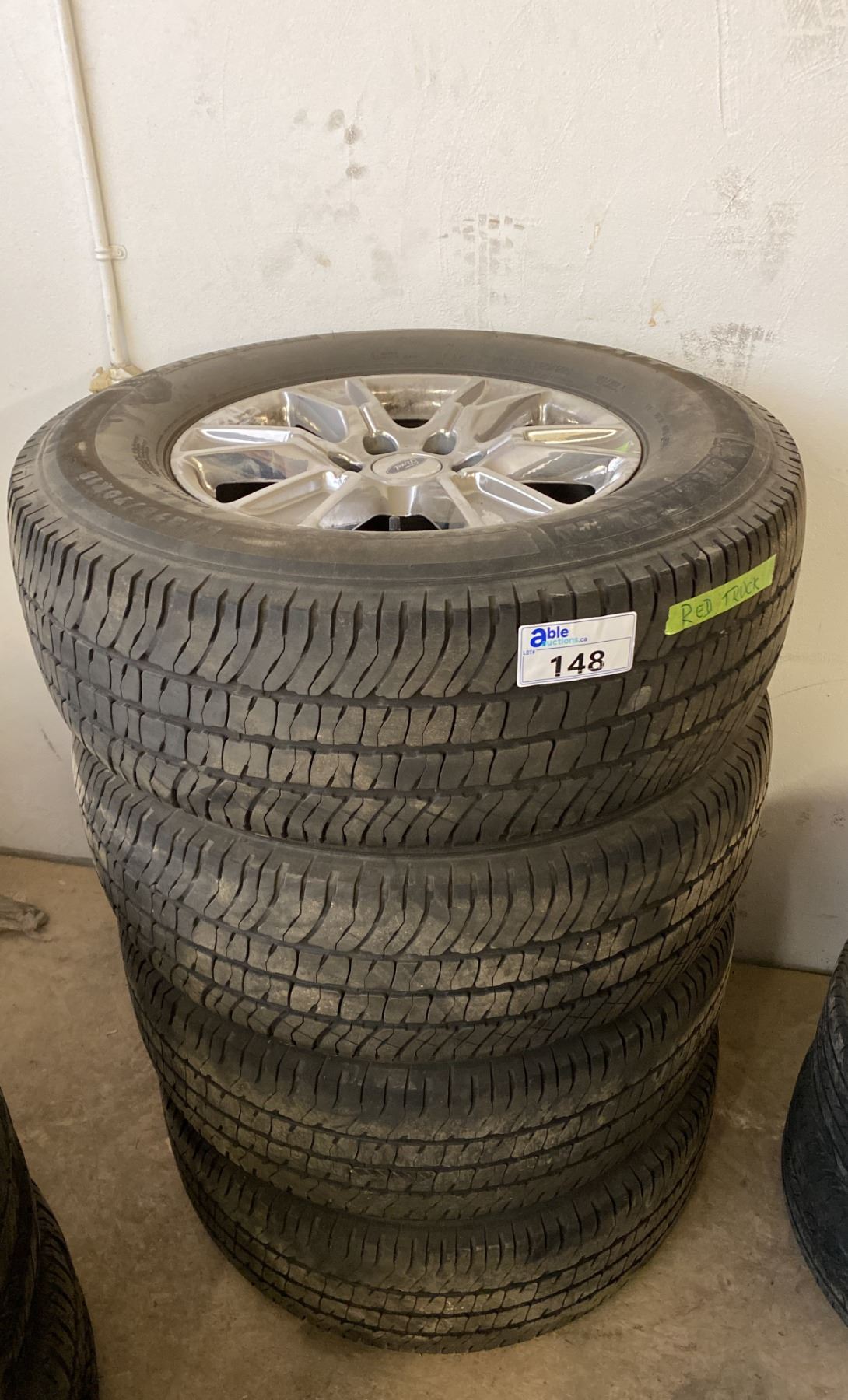 SET OF 4 USED FORD POLISHED ALUMINUM TIRES AND RIMS. 18
