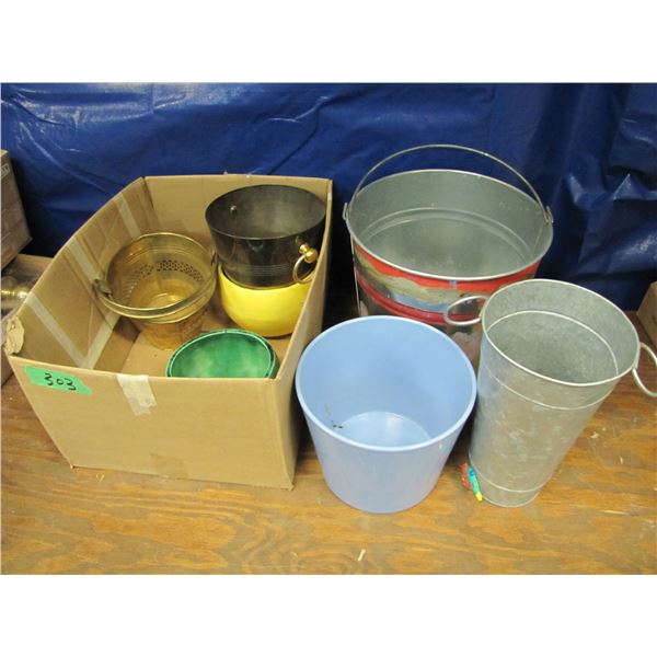 Box with various tin pails and pots for plants