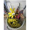 Image 1 : green garbage barrel with hand saw, extention cord etc.