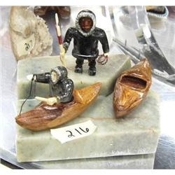 Pair of soapstone hunters and 2 wooden qayaq mounted on soapstone made by Simon Kinnok (2)