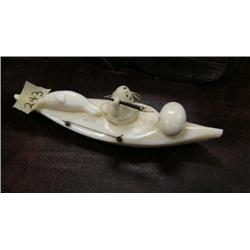 White carved ivory hunter in qayaq with seal and seal poke and baleen handled harpoon- 1-1/4" tall, 