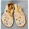 Image 1 : Child's beaded moccasins in display case