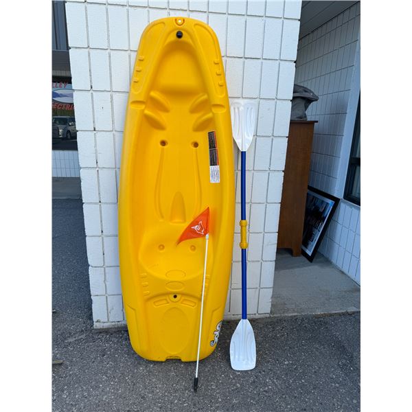 Pelican kyak with paddle and flag