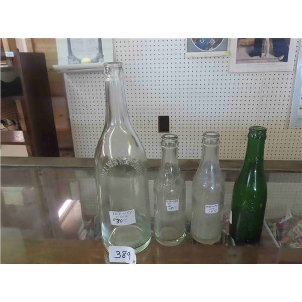 4 Bottles Drewry Embossed ; 3 Clear, 1 Green with Embossed Mountie