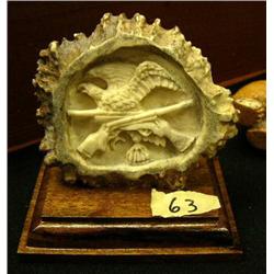 Antler carving of eagle and 2 rifles on wood base (2)