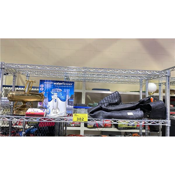 SHELF OF ASSORTED ITEMS INCLUDING; WATERPIK WATERFLOSSER, DESK LAMP, MATCHES & MORE