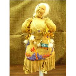 Wood face doll, tanned moose hide 11" tall, signed but unreadable, heavily beaded dress, seal skin b