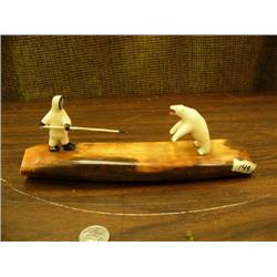 White walrus ivory hunter and bear 2.5" tall circa 1960 mounted on 9" approx. 9 lb. chocolate brown 