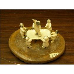 Blanket toss carving with 7 men mounted on fossilized whale disk, ornate super quality, circa 1960 G