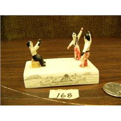 Dancing 1.5" figures painted, with red pants and black pants, base of ivory scrimshawed with seal, w