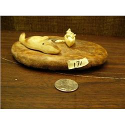 Hunting scene of 2 men in umiak bringing in walrus- carved out of 3.5" ivory mounted on fossilized w