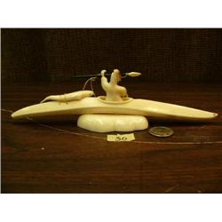 9.5" White ivory kayaker with baleen harpoon, fossilized ivory face and an ivory seal by Paul Rookok