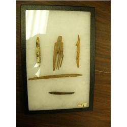 Group of 4 ancient fossilized ivory artifacts from Gambell, Alaska: comb, bird harpoon, part of a fi