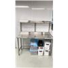 Image 1 : STAINLESS STEEL TABLE WITH BACKSPLASH AND SHELF APPROX 5' X 2' X 3' WITH GOWNS, HOODS AND MASKS
