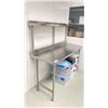 Image 3 : STAINLESS STEEL TABLE WITH BACKSPLASH AND SHELF APPROX 5' X 2' X 3' WITH GOWNS, HOODS AND MASKS
