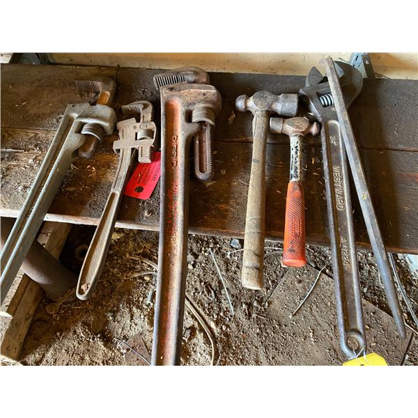 Crescent wrench, bars, pipe wrenches, hammers.