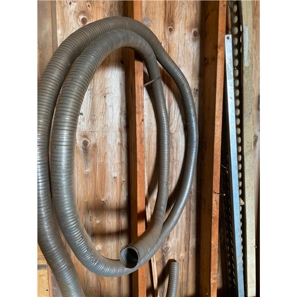 Exhaust hose, chains, 2 red hyd. rams, air hose, rain jackets, rope. All items on north wall.