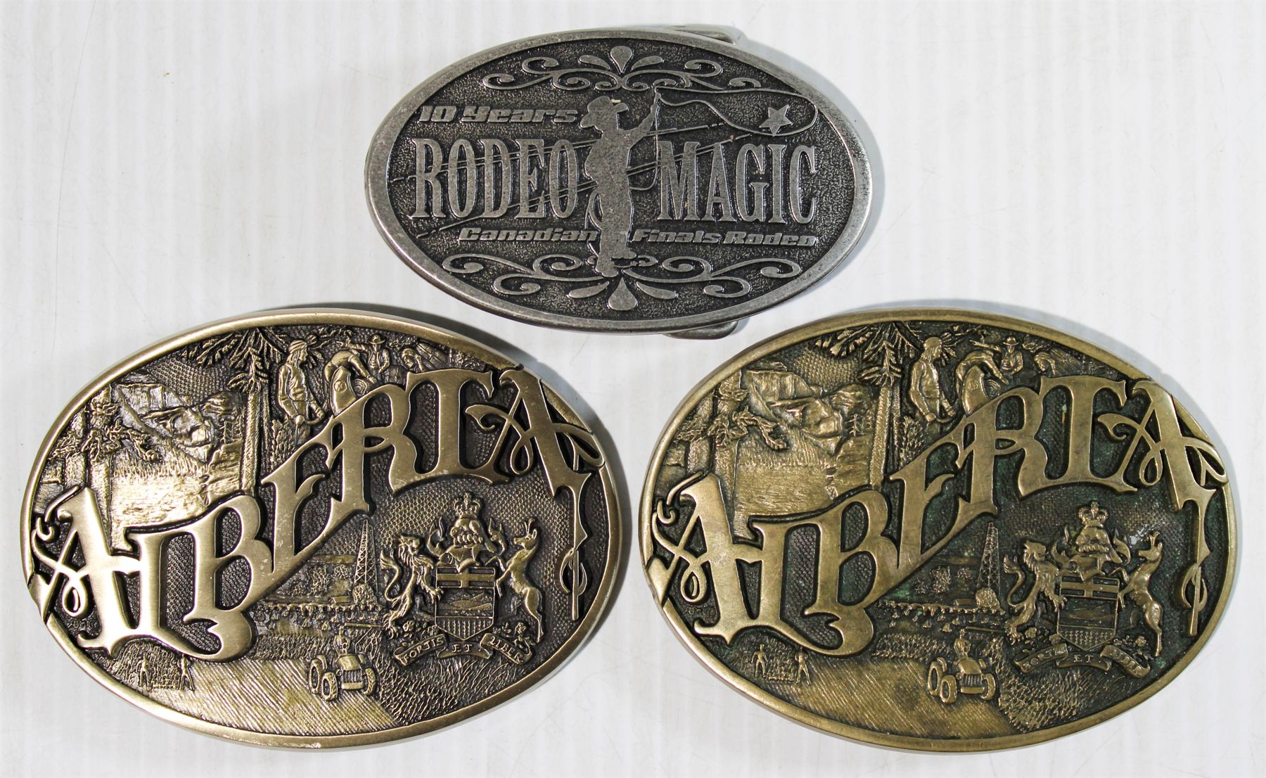 THREE CANADIAN RODEO BELT BUCKLES