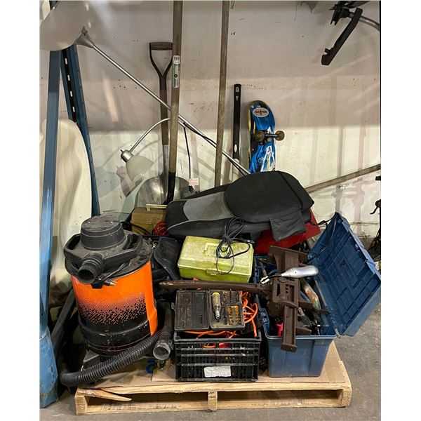 Pallet lot containing shop vac, vertical jack, shovels, skateboard, lamps, extension cords, misc. ha
