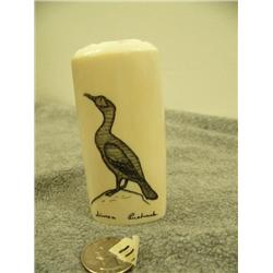 Ivory piece scrimshawed with cormorant and puffin with ivory face on top with inlayed baleen eyes by