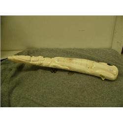Ivory tusk cribbage board made to look like a whale with relief carvings of walrus, bear, seals, and