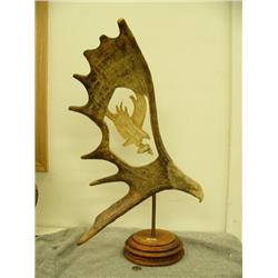 Moose antler carved with eagle's head and center carved with eagle with salmon mounted on wood by B.