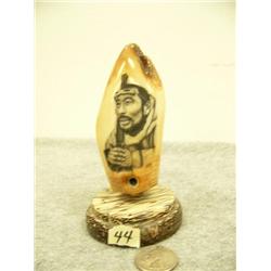 Fossilized whale tooth mounted on wood scrimshawed with Eskimo man holding gun with snow goggles 5" 