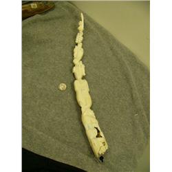 Carved tusk with man, spotted seal with pup, seal with pup, walrus with baby, 2 whales and polar bea