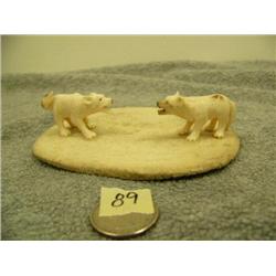 Carved ivory wolves on bone disk 1.25" tall 4.25" long by L.A.I. (33)