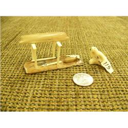Lot of 2: carved walrus by H. Iyakitan- 1" tall, 1.5"; fossilized ivory umiak on wood stand with woo