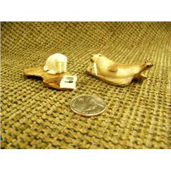 Lot of 2: fossilized ivory walrus with white ivory tusks 7/8"x2.5" and ivory walrus on fossilized iv