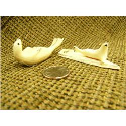 Lot of 2: fossilized ivory seal by Arnold Iyakitan 2.5" and seal on ivory base by Harrison Iyakitan 