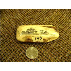 Fossilized ivory scrimshawed with ship and sea dragon by K.E.H. 3.5" long (74)
