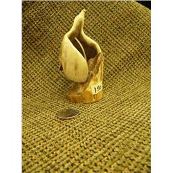 Fossilized ivory flying eagle mounted on fossilized ivory with inset baleen eyes by R.A.J. 4.5" tall