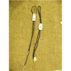 Lot of 2 ivory bolo ties: scene of cache; other of polar bear (2)